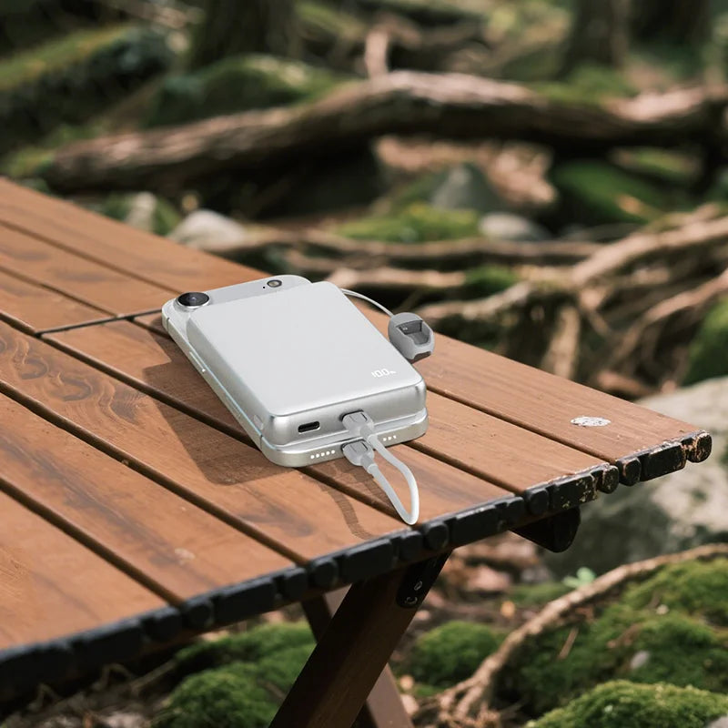 ZikeTech solid-state power bank charges iPhone 16 on camping table